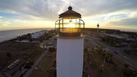 Flying and descending behind a lighthouse with sunset in the distance. Stock Footage 90560908