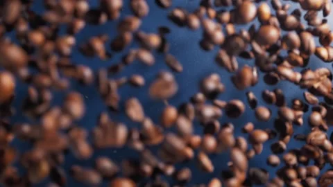 Flying up and Falling down Roasted Coffee Beans and cinnamon on blue background Stock Footage 147861459