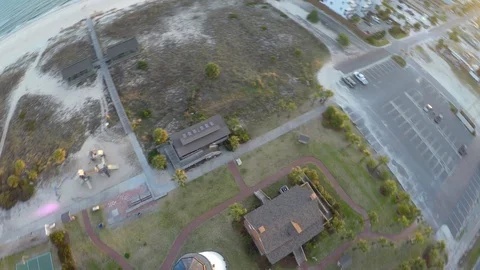 Flying and looking stright down over a lighthouse, rotating and flying backwards Stock Footage 90561288