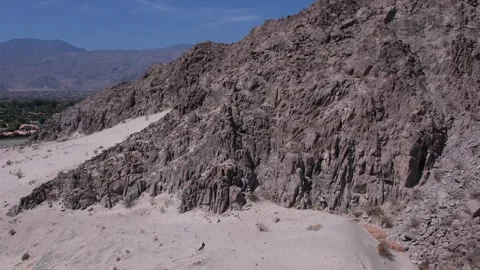 Flying up and over mountain in the desert Stock Footage 246334496