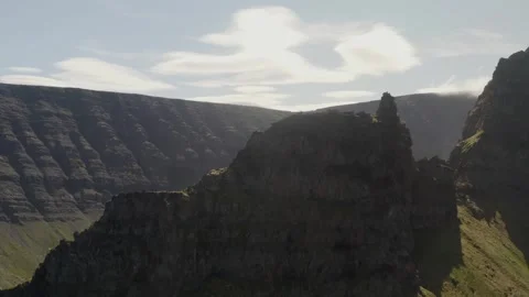 Flying up and over the peak of Svalvogar mountain in the Western Fjords of Stock Footage 255014525