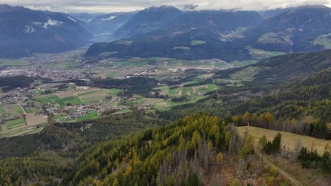 Flying and panning left across the Puster Valley with Bruneck the largest city Stock Footage 327124563