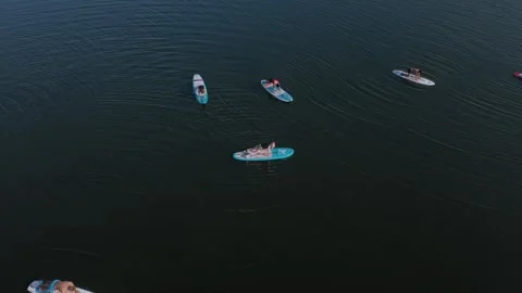 Flying and shooting from a drone’s camera in a circle over a group of people Video stock 130651585