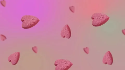 Flying and wiggle of different diameters many pink candy in the shape of heart Stock Footage 168589086