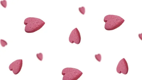 Flying and wiggle of different diameters many pink candy in the shape of heart Stock Footage 168589087