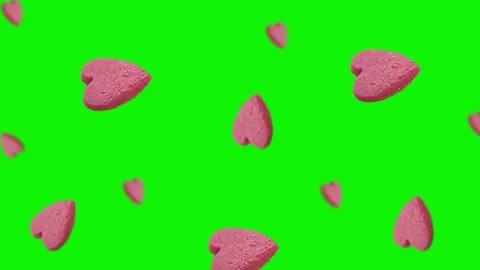 Flying and wiggle of different diameters many pink candy in the shape of heart Stock Footage 168589107