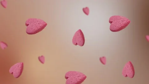 Flying and wiggle of different diameters many pink candy in the shape of heart Stock Footage 168589124
