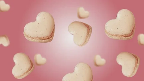 Flying and wiggle of different diameters many heart shaped vanilla macaroons Stock Footage 168619225