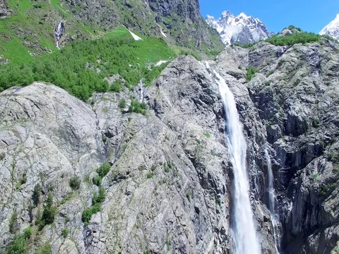 Flying approaching to Waterfall in stone Mountains Aerial 4K video Stock Footage 80314498