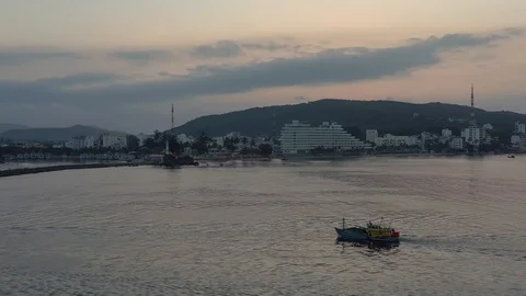 Flying around boat floating alone in sea water with island on background and mo Video stock 124106684