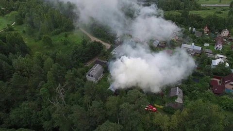 Flying around a burning house in the forest village. Aerial view. 스톡 동영상 74853074