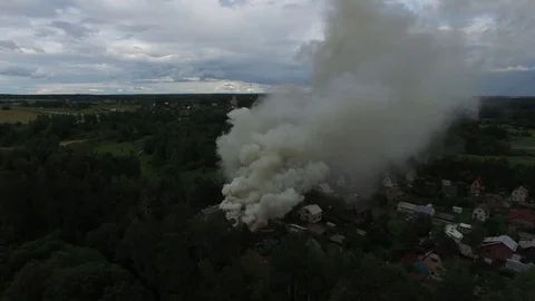 Flying around a burning house in the forest village. Aerial view. Stock Footage 74853247