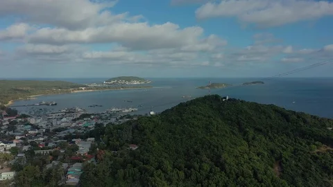 Flying around cable car above trees on the mountain covered with forest green tr Stock Footage 124366114