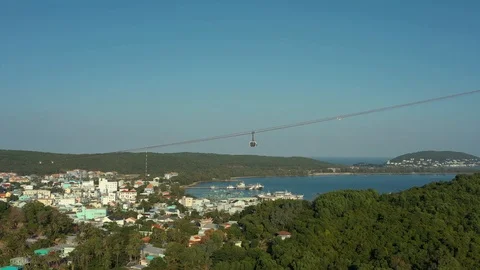 Flying around cable car above old town fishing village at the beach shore in su Stock Footage 124366510