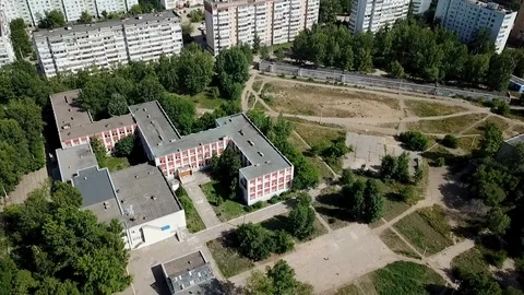 Flying around the camera around the school, which is in the yard Stock Footage 93449376