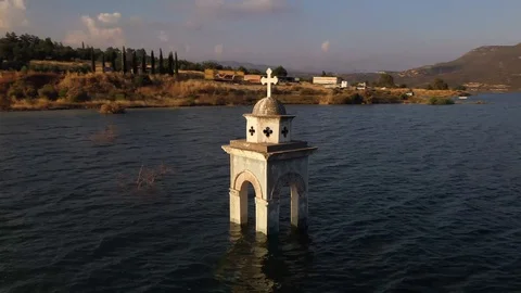 Flying around church's tower in the middle of the lake Stock Footage