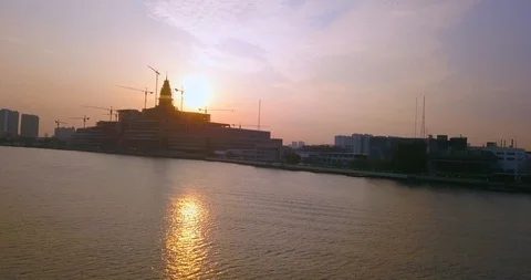 Flying around construction building in front of sun early in the morning Stock Footage 108573732