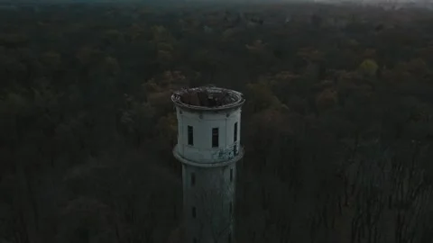Flying around the destroyed water tower in the forest, cold day, sunset. Stock Footage 146410852