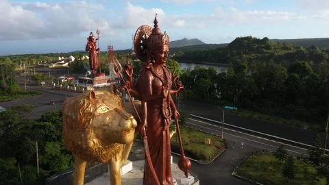Flying around the Durga Mata monument in Ganga Talao in Mauritius Stock Footage 123458100