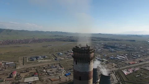 Flying around a flue gas stack chimney of a thermal coil power station. Drone  Stock Footage 98207925