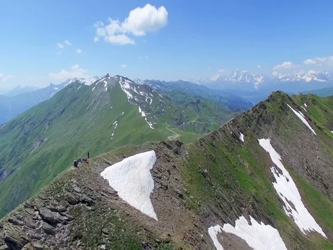 Flying around group of hikers tourists over mountain range Aerial 4k video Stock Footage 80314583