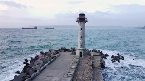 Flying around the lighthouse on a drone early in the morning at sunrise Stock Footage 221905878