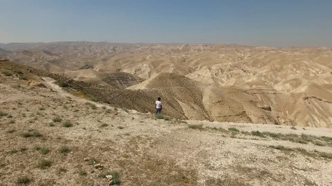 Flying around man at the lookout over Wadi Qelt. Judaean Desert. DJI-0194-05 Stock Footage 124444553