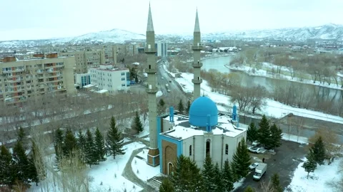 Flying around the mosque with a blue dome on a drone with a view of the surround Stock Footage 240530883