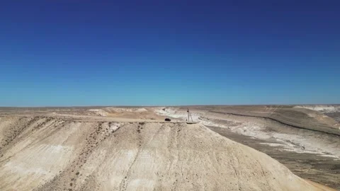 Flying around the mountain on top of which there is a car with tourists Stock Footage 237696987