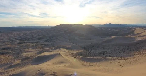 Flying around Mt. Kelso's sand dunes in Mojave National Preserve at sunset Stock Footage 73529038