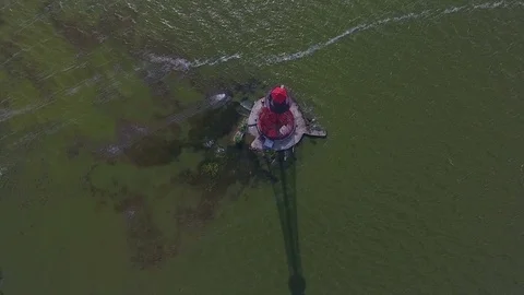 Flying around old lighthouse in sea Stock Footage 77157510