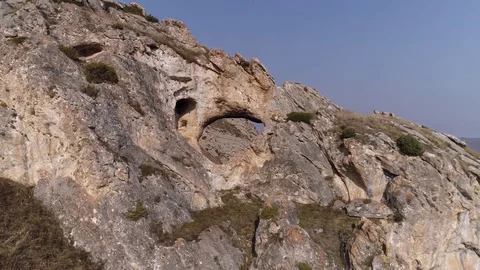 Flying around a rock with a hole Stock Footage 83733255