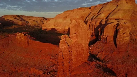 Flying around rocket tower at sunrise in Monument Valley Stock Footage 89021576