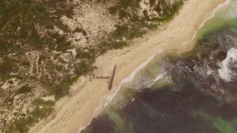 Flying around a shipwreck on an empty ocean beach Stock Footage 94450202