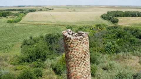 Flying around the top of an old brick chimney in the fields Stockbeeldmateriaal 137721589