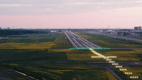 Flying around touchdown zone of Tallinn airport runway in sunset with Stock Footage 140995741
