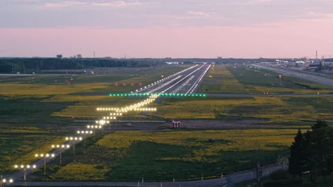 Flying around touchdown zone of Tallinn airport runway in sunset with Stock Footage 140995821
