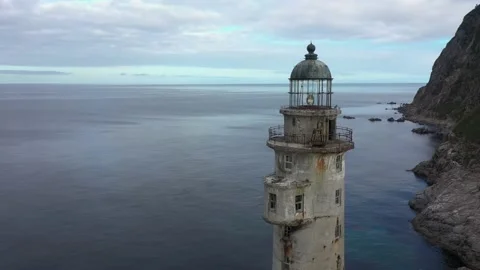 Flying Around a Tower of Lighthouse Aniva on the Rock in Sakhalin Island Video stock 163886294