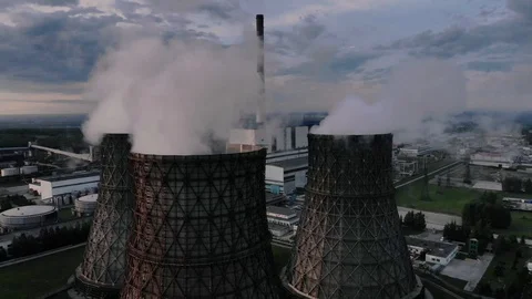 Flying around the tower of a nuclear power plant at sunrise Stock Footage 109316098