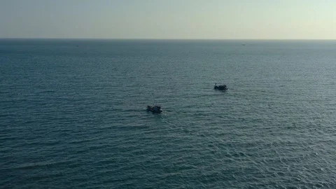 Flying around two boats floating simultaneously to the horizon on sea water wit Stock Footage 124106865