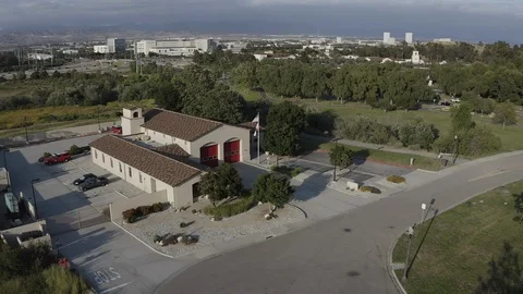 Flying around a US Fire Station in Orange County California with a US Flag Stock Footage 109441446
