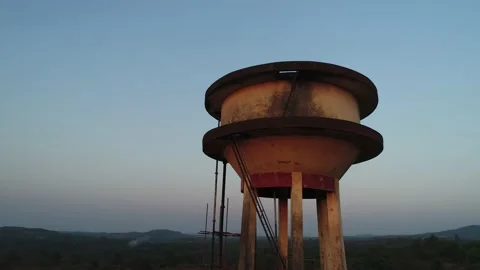 Flying around a water tower in a small Indian village. Aerial view. Stockbeeldmateriaal 85517620