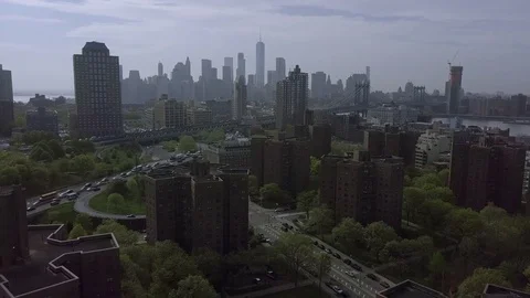 Flying Away from Housing Projects with the New York Skyline Behind Them Stock Footage 75508437