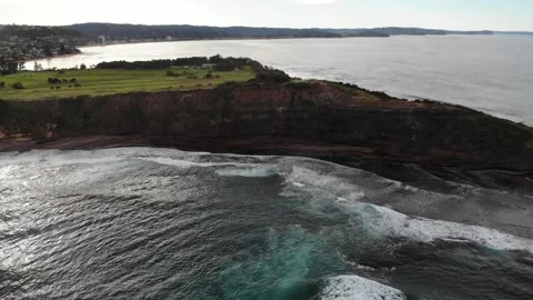 Flying away a mountain and waves to reveal the full size Stock Footage 135579417
