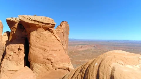 Flying away from the red cliffs tops with wavу pattern. Monument Valley Aerial Stock-Footage 114459374
