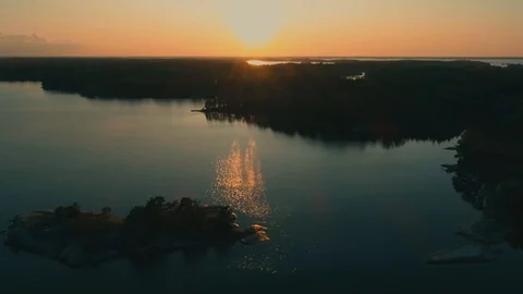 Flying away from the setting sun over the Scandinavian archipelago Video stock 114004473