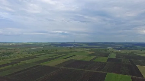 Flying away from a single wind turbine on rural agricultural fields Stock Footage 99479853
