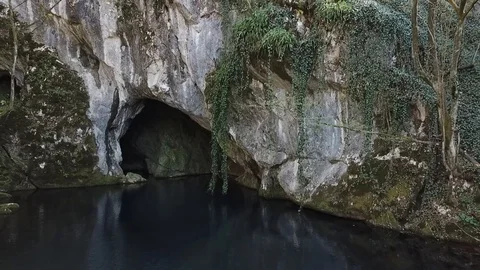 Flying away from the spring above crisp clear lake water and revealing a smal Stock Footage 106158550
