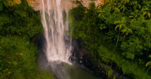 Flying away from Spring brook waterfall bottom in 4k UHD Stock Footage 99752708