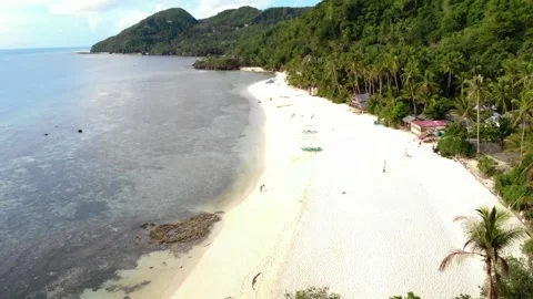 Flying away from the white beach with mountain background Stock Footage 138976924